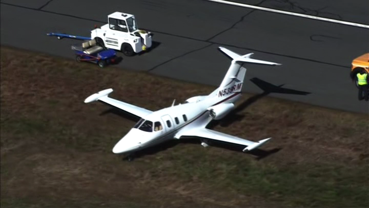 Small plane slides off runway at Norwood Airport