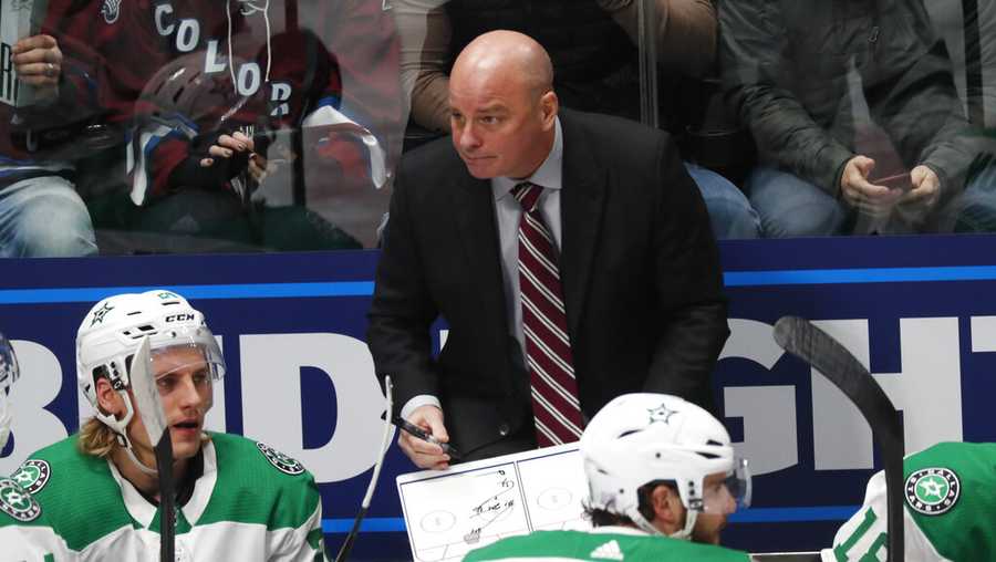 Dallas Stars coach Jim Montgomer draws up a play during a timeout in the first period of the team&apos;s NHL hockey game against the Colorado Avalanche on Friday, Nov. 1, 2019, in Denver. (AP Photo/David Zalubowski)