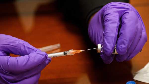 A Culver City Fire Department  paramedic prepares a syringe with a dose of the Johnson and Johnson Janssen Covid-19 vaccine at a vaccination clinic on August 5, 2021, in California.