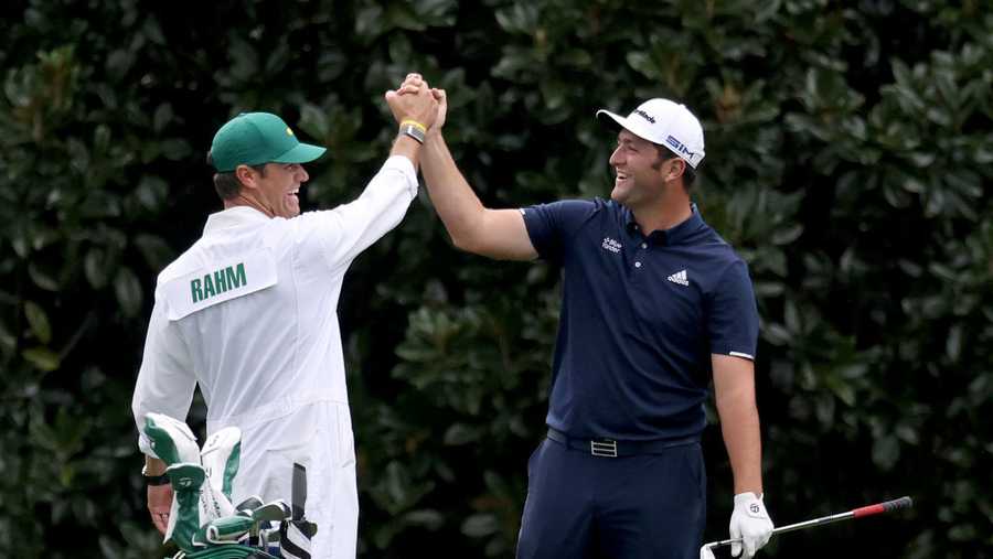 Jon Rahm of Spain celebrates with his Adam Hayes after skipping in for a hole in one on the 16th during a practice round prior to the Masters at Augusta National Golf Club on November 10, 2020 in Augusta, Georgia.