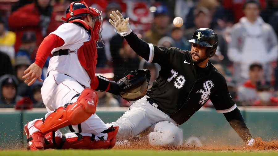 Chicago White Sox's Jose Abreu (79) is safe at home plate against Boston Red Sox's Christian Vazquez on the single by Luis Robert during the 10th inning of a baseball game, Saturday, May 7, 2022, in Boston.