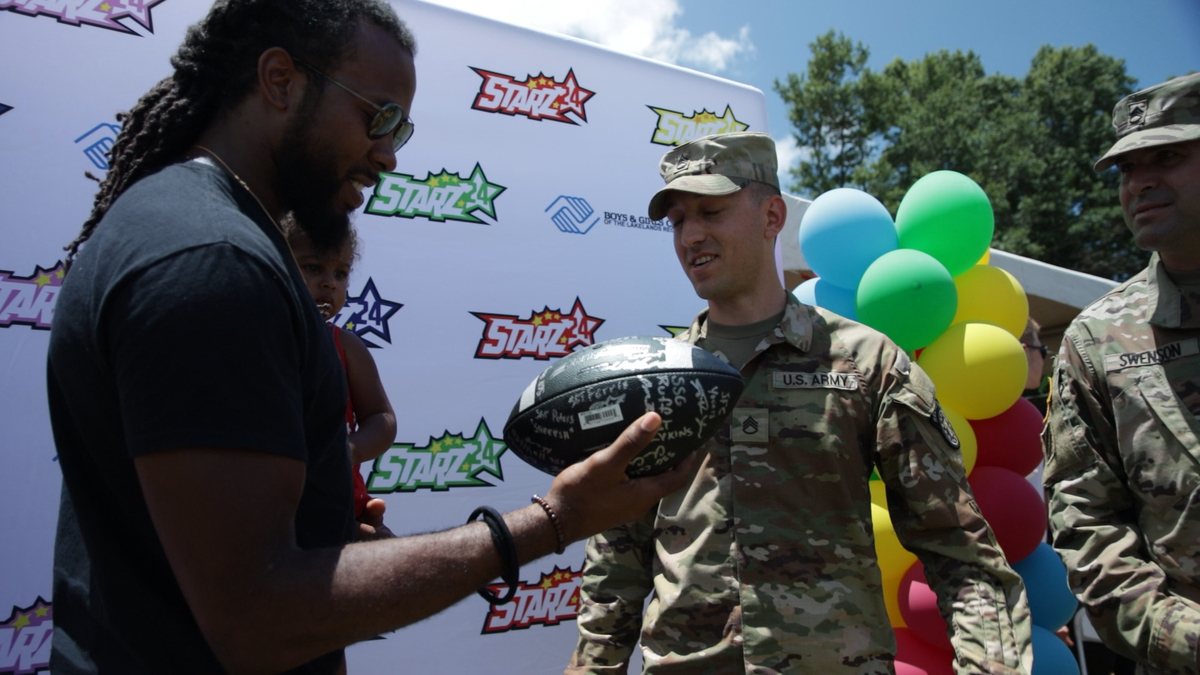 Josh Norman holds STARZ24 Foundation Fun Day