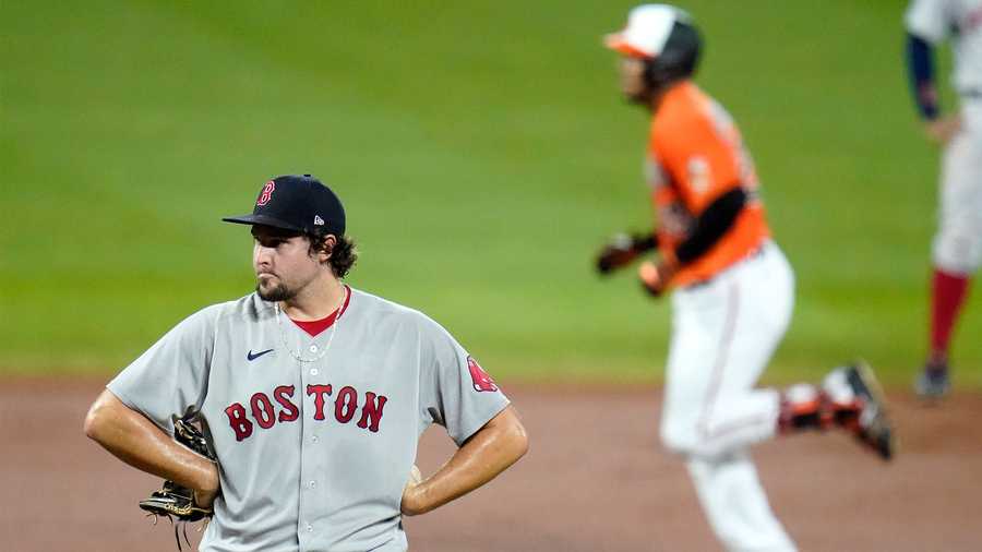 Boston Red Sox relief pitcher Josh Taylor, left, as Baltimore Orioles' Anthony Santander, right, runs the bases after hitting a two-run home run off him during the eighth inning of a baseball game, Saturday, Aug. 22, 2020, in Baltimore. The Orioles won 5-4 in ten innings. (AP Photo/Julio Cortez)