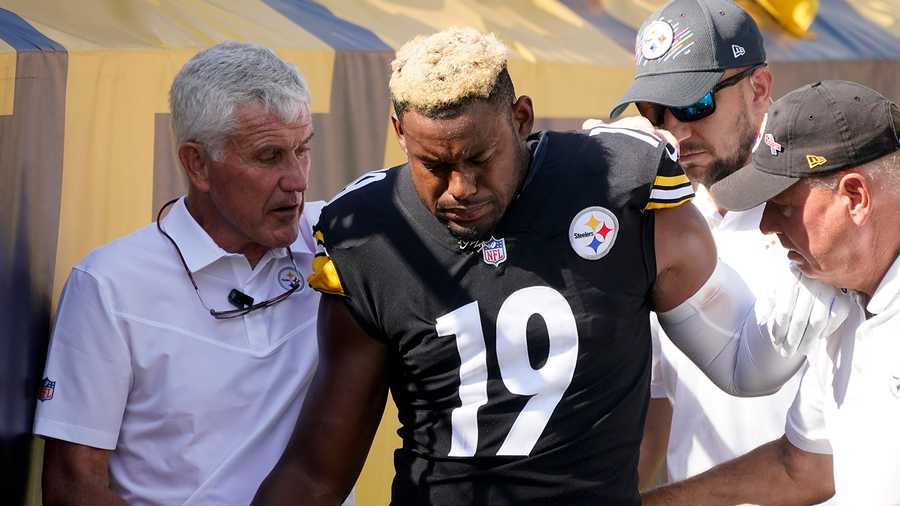 JuJu Smith-Schuster is helped off the field after being injured against the Broncos.