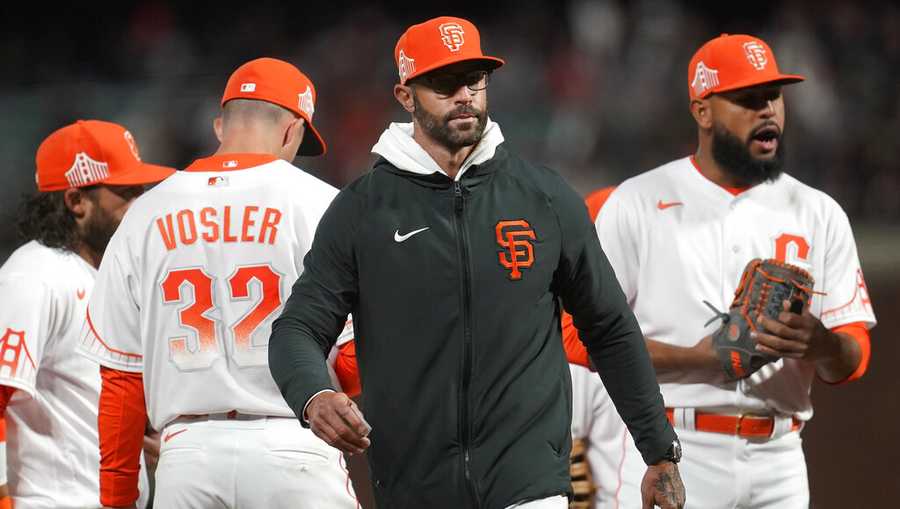 San Francisco Giants manager Gabe Kapler, middle, walks toward the dugout after making a pitching change during the sixth inning of the team&apos;s baseball game against the Washington Nationals in San Francisco, Friday, April 29, 2022.