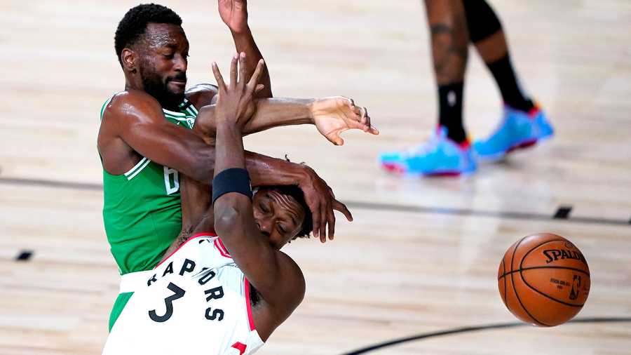 Boston Celtics' Kemba Walker, top, and Toronto Raptors' OG Anunoby collide while competing for possession during the first half of an NBA basketball game Friday, Aug. 7, 2020 in Lake Buena Vista, Fla. (AP Photo/Ashley Landis, Pool)