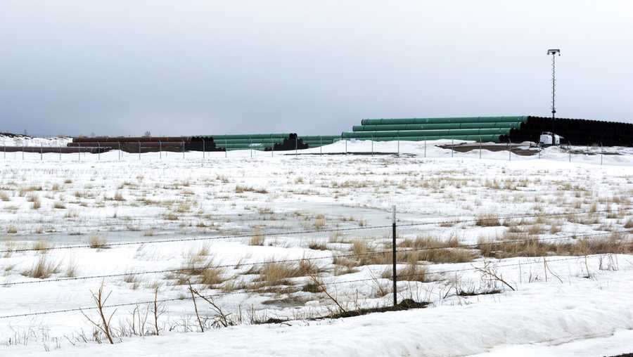 This March 11, 2020 photo provided by the Bureau of Land Management shows a storage yard north of Saco, Mont., for pipe that will be used in construction of the Keystone XL oil pipeline near the U.S.-Canada border. A Canadian company said April 6, 2020, that it's started construction on the long-stalled Keystone XL oil sands pipeline across the U.S.-Canada border, despite calls from tribal leaders and environmentalists to delay the $8 billion project amid the coronavirus pandemic. (Al Nash/Bureau of Land Management via AP)