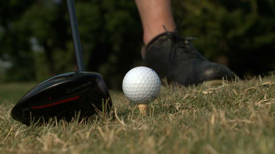 a golfer gets ready to tee off