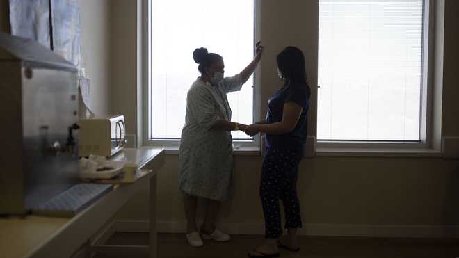 Randa Aweis, left, who received a kidney transplant from Yigal Yehoshua, a Jewish man who died May 17 after being pelted with rocks amid clashes between Arabs and Jews in Israel’s mixed city of Lod, speaks with her daughter, Nevine at Hadassah Ein Karem Hospital in Jerusalem, Monday, May 24, 2021.