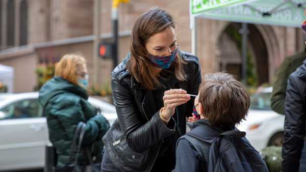 FILE - Katie Lucey administers a COVID-19 test on her son Maguire at a PCR and Rapid Antigen COVID-19 coronavirus test pop up on Wall Street in New York on Thursday, Dec. 16, 2021.