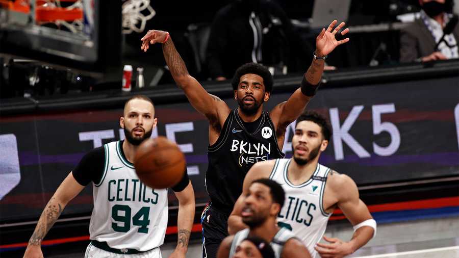 Brooklyn Nets guard Kyrie Irving watches his shot go in the basket next to Boston Celtics forward Jayson Tatum in the second half of Game 5 during an NBA basketball first-round playoff series, Tuesday, June 1, 2021, in New York. (AP Photo)