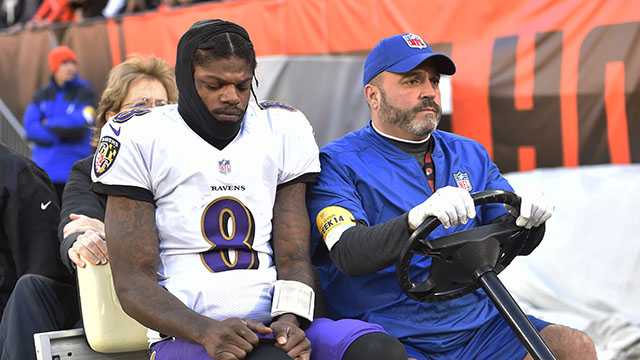 Baltimore Ravens quarterback Lamar Jackson (8) is carted off the field after an injury during the first half of an NFL football game against the Cleveland Browns, Sunday, Dec. 12, 2021, in Cleveland. (AP Photo/David Richard)