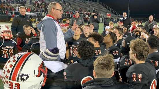 Head coach Pat McLaughlin talks to his team after the Lancers Division II state semifinal win over Toledo Central Catholic.