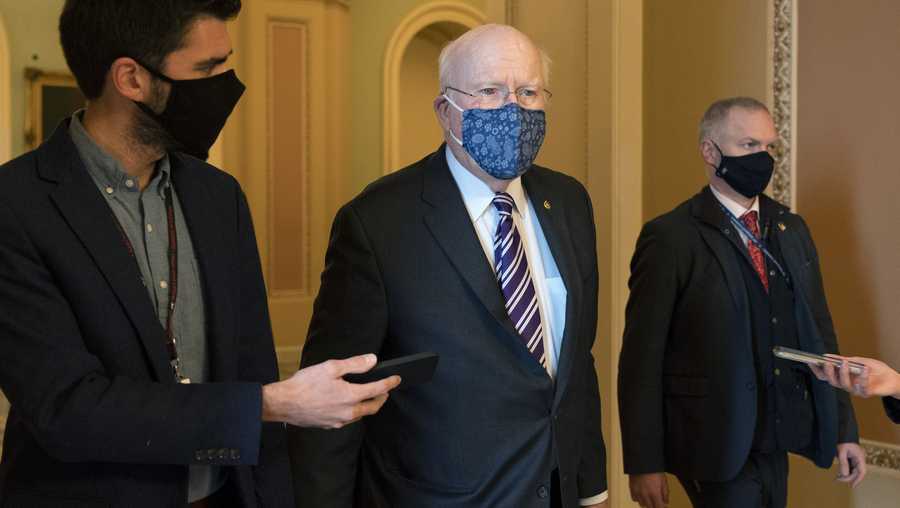 Sen. Patrick Leahy, D-Vt., walks with reporters, Tuesday, Jan. 26, 2021, as he leaves the Senate floor on Capitol Hill in Washington.