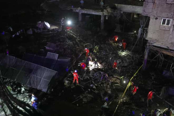 Lebanese Red Cross volunteers search for possible victims in a building destroyed by an Israeli airstrike in the southern port city of Sidon, Lebanon, early Tuesday, Jan. 6, 2026.