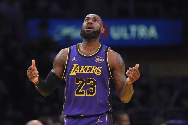 Los Angeles Lakers forward LeBron James looks at a replay after a call went against them during the second half of an Emirates NBA Cup basketball game against the Oklahoma City Thunder on Friday, Nov. 29, 2024, in Los Angeles.