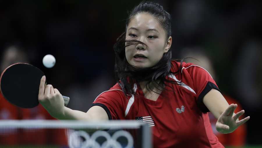 Lily Zhang of the United States plays against Xiao Na Shan of Germany during their women&apos;s team table tennis first round match at the 2016 Summer Olympics in Rio de Janeiro, Brazil, Friday, Aug. 12, 2016. (AP Photo/Petros Giannakouris)