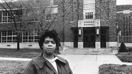 Linda Brown Smith stands in front of the Sumner School in Topeka, Kansas, on May 8, 1964. The refusal of the public school to admit Brown in 1951, then nine years old, because she is black, led to the Brown v. Board of Education of Topeka, Kansas. In 1954, the U.S. Supreme Court overruled the "separate but equal" clause and mandated that schools nationwide must be desegregated. 