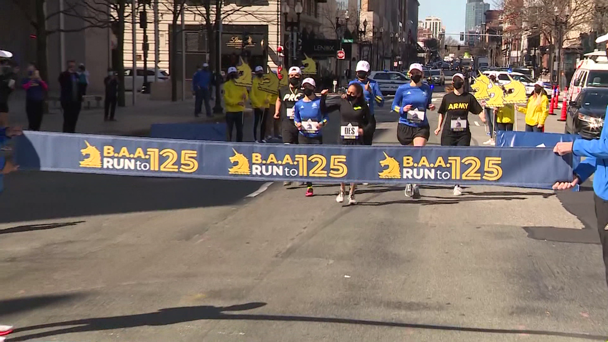 Frontline workers cross Boston Marathon finish line with former champ