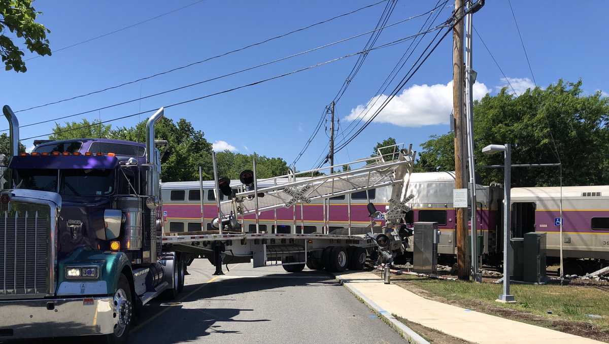 Commuter rail train hits tractor trailer at street crossing