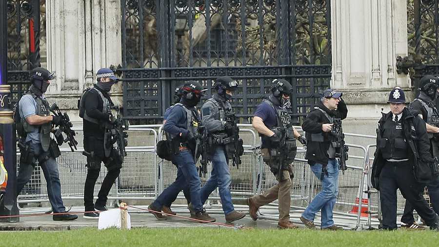 Armed police officers enter the Houses of Parliament in London, Wednesday, March 23, 2017 after the House of Commons sitting was suspended as witnesses reported sounds like gunfire outside. The leader of Britain's House of Commons says a man has been shot by police at Parliament. David Liddington also said there were "reports of further violent incidents in the vicinity."