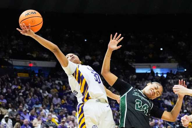 LSU guard Jada Richard (30) and Jacksonville guard Makiya Miller (24) battle under the basket during the second half in the first round of the NCAA college basketball tournament, Friday, March 20, 2026, in Baton Rouge, La.
