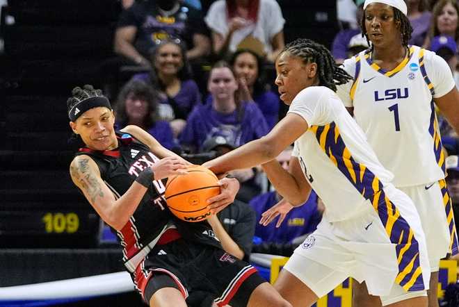 Texas Tech guard Snudda Collins (0) battles for control against LSU guard Mikaylah Williams during the first half in the second round of the NCAA college basketball tournament, Sunday, March 22, 2026, in Baton Rouge, La.