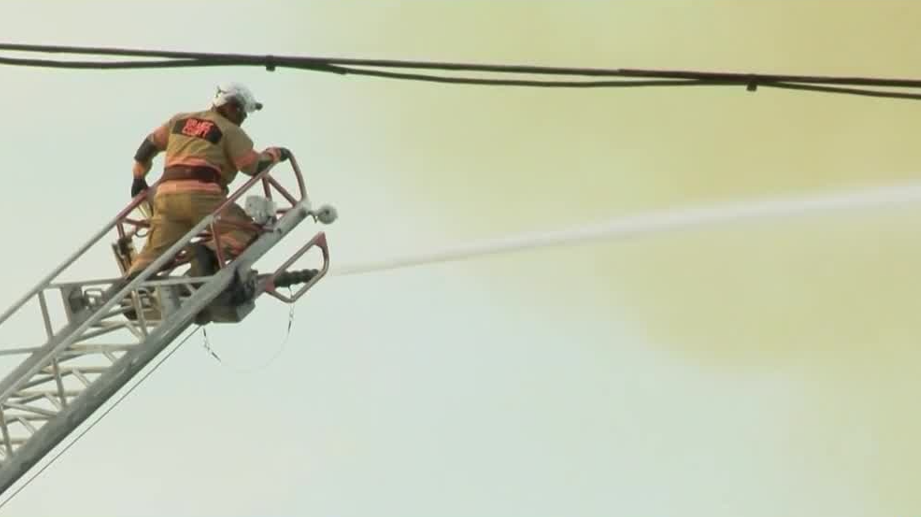 Orange County firefighters work to extinguish lumber yard blaze