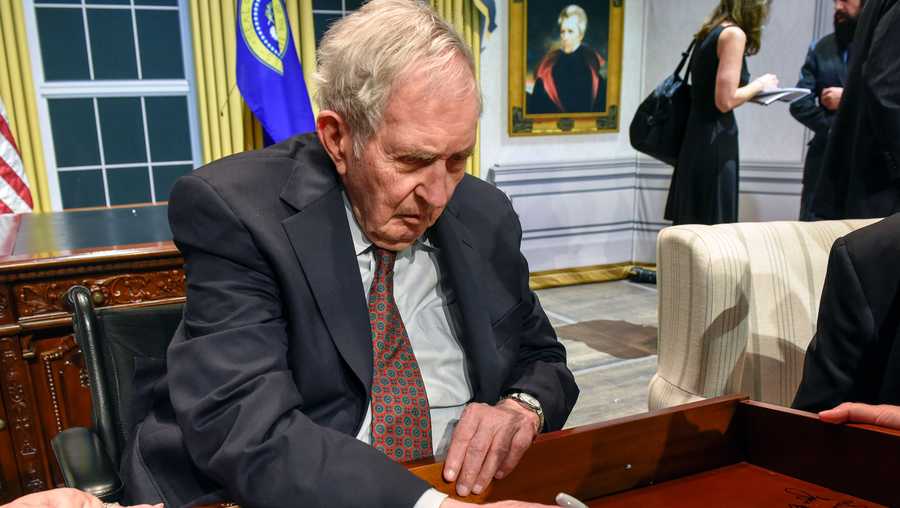 Lyon Gardiner Tyler Jr. signs his name on the inside of a desk drawer with other descendants of past presidents who gathered in Washington in August 2018.
