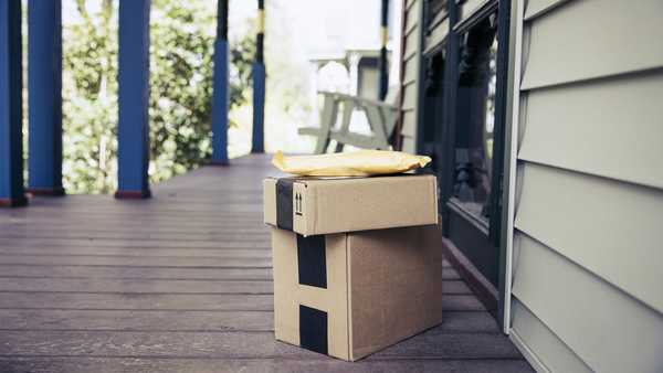 stack of packages on front porch after mail delivery