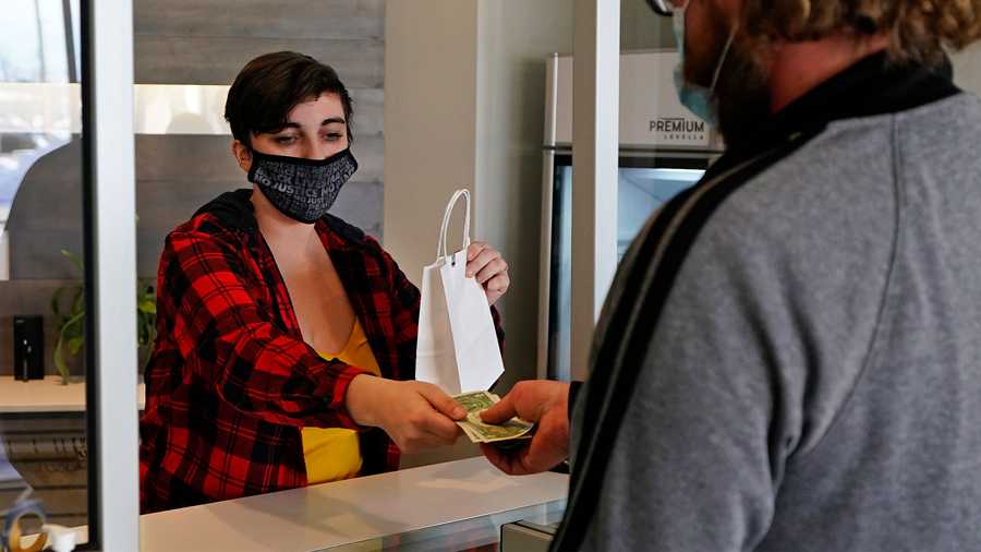 Marijuana is sold at Theory Wellness, a cannabis retail store, Thursday, Jan. 7, 2021, in South Portland, Maine. Cannabis has rocketed to the top of the state's agricultural crops, but the first few months of legal adult use sales have otherwise been without much fanfare. (AP Photo)