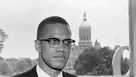 Malcolm X, leading spokesman for the Black Muslim movement, is shown with the dome of the Connecticut Capitol behind him as he arrived in Hartford for a two day visit.