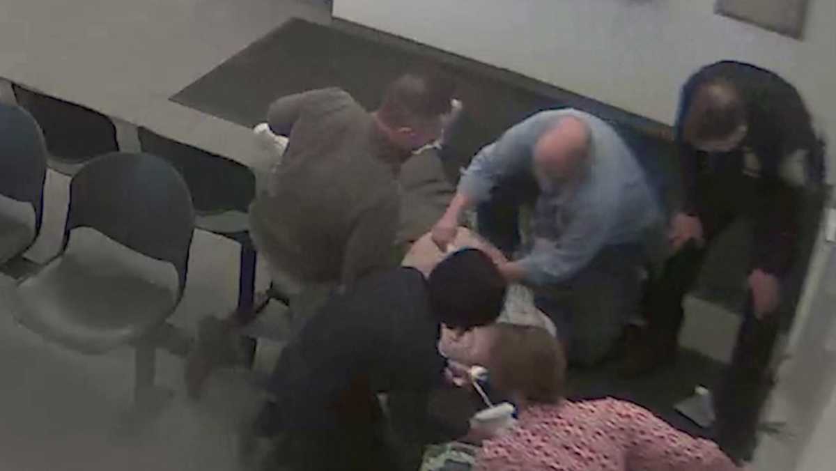 Officers Administer Cpr To Man Sitting In Police Station Lobby