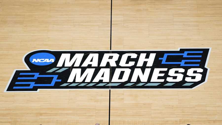 FILE -The March Madness logo is shown on the court during the first half of a men's college basketball game.