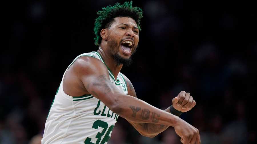 Boston Celtics guard Marcus Smart celebrates after the Celtics scored during the second half of an NBA basketball game against the Charlotte Hornets, Monday, Nov. 28, 2022, in Boston.