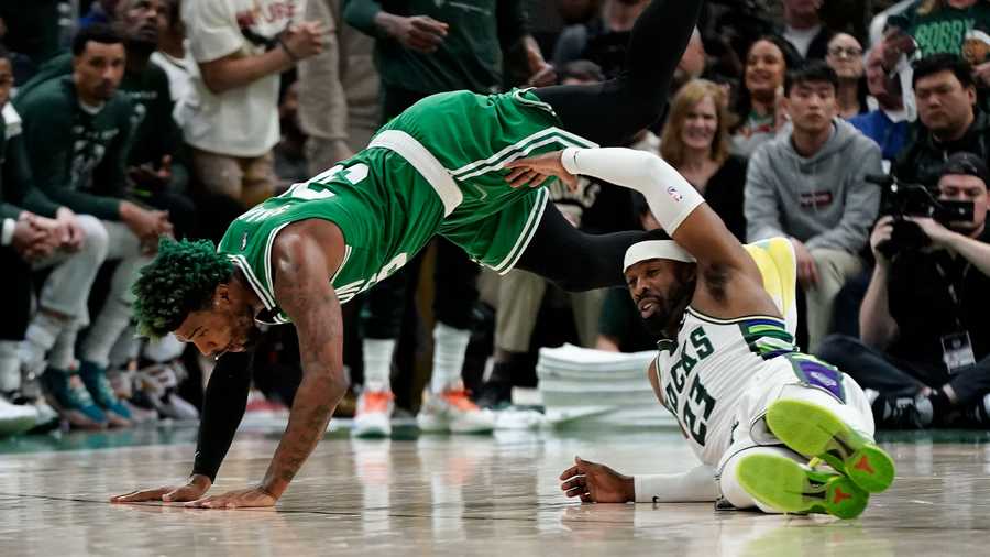 Milwaukee Bucks' Wesley Matthews fouls Boston Celtics' Marcus Smart during the second half of Game 3 of an NBA basketball Eastern Conference semifinals playoff series Saturday, May 7, 2022, in Milwaukee. The Bucks won 103-101 to take a 2-0 lead in the series.