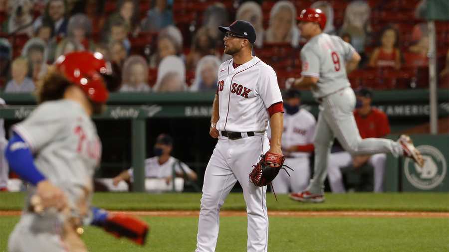 Boston Red Sox relief pitcher Marcus Walden watches the ball after Philadelphia Phillies' Jay Bruce (9) hit a three-run home run during the eighth inning of a baseball game Tuesday, Aug. 18, 2020, at Fenway Park in Boston. (AP Photo/Winslow Townson)