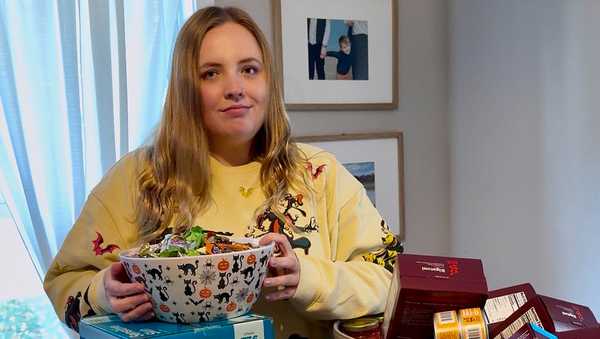 This photo provided by Taylor Martin shows her with shelf-stable foods and other supplies to give out to trick-or-treaters on Wednesday, Oct. 29, 2025, in La Porte, Ind.