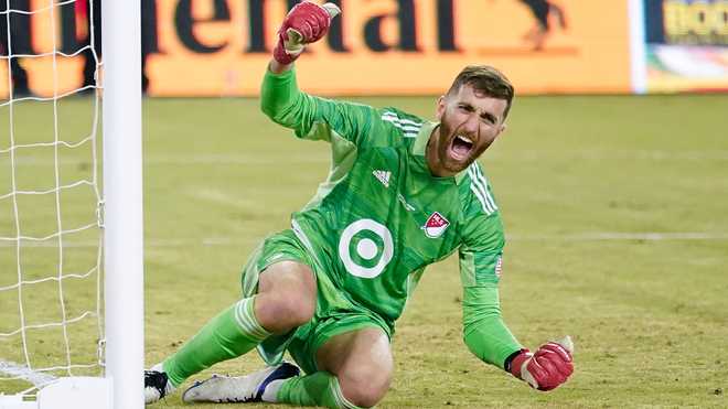 New England Revolution goalkeeper Matt Turner (30) celebrates after making a save during a penalty shoot out at the end of the MLS All-Star soccer match against the Liga MX All-Stars Wednesday, Aug. 25, 2021, in Los Angeles. (AP Photo)