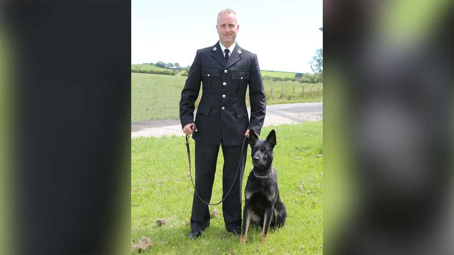 Police dog Max poses with handler PC Peter Lloyd.