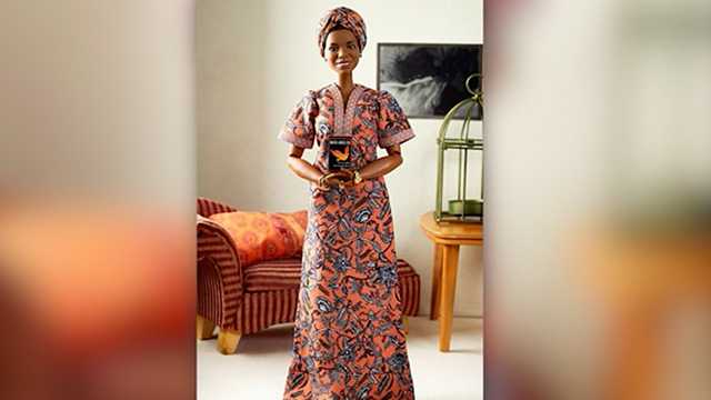 Mattel's Maya Angelou Barbie doll is shown holding a miniature version of the author's book.