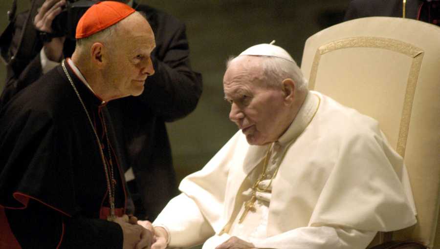 Pope John Paul II (R) greets Washington's Archbishop Cardinal Theodore Edgar McCarrick at the Pope's weekly general audience January 15, 2003 in Vatican City.