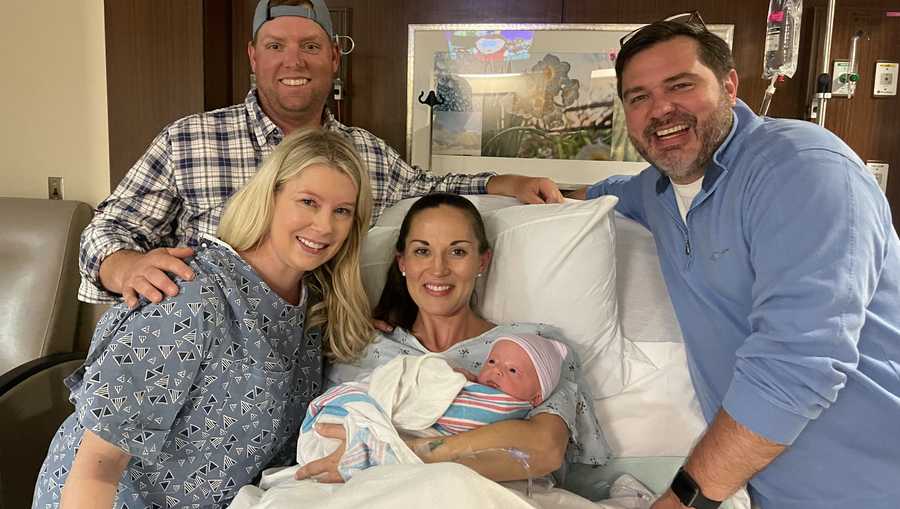 Two couples and a newborn in a hospital room