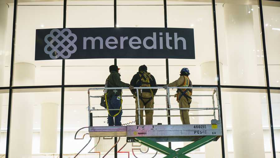 Workers cover up Time Inc. signage with Meredith Corporation signage at the Time Inc. office building in Lower Manhattan, January 31, 2018 in New York City.
