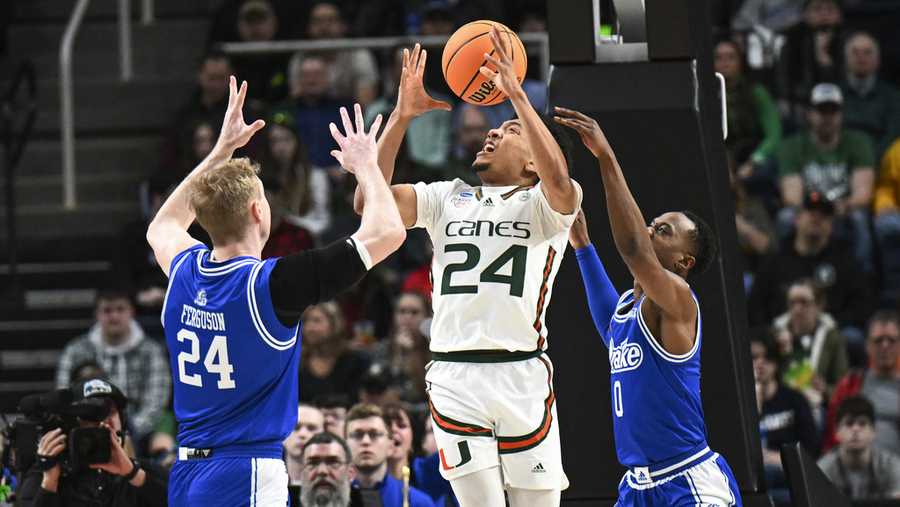 Nate Ferguson,D.J. Wilkins,Nijel Pack Drake forward Nate Ferguson (24) and guard D.J. Wilkins (0) defend against Miami guard Nijel Pack, center, during the first half of a first-round college basketball game in the men's NCAA Tournament Friday, March 17, 2023, in Albany, N.Y.
