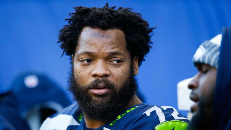 Defensive end Michael Bennett, then with the Seattle Seahawks, sits on the bench while the offense plays against the Arizona Cardinals at CenturyLink Field on December 31, 2017 in Seattle, Washington.