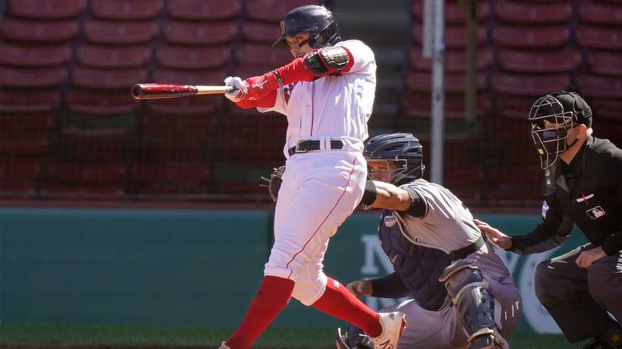 Boston Red Sox's Michael Chavis, left, hits a three-run home run as New York Yankees' Gary Sanchez, behind center, looks on in the third inning of a baseball game, Sunday, Sept. 20, 2020, in Boston. (AP Photo/Steven Senne)