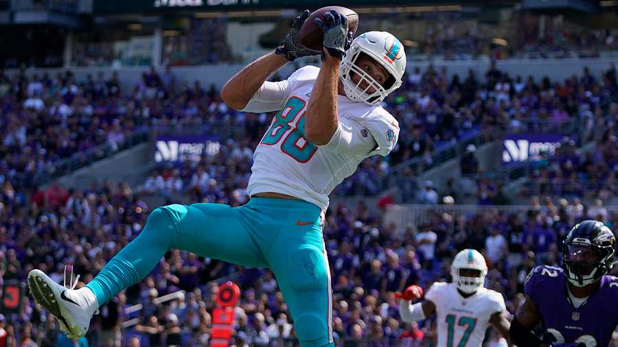 Miami Dolphins tight end Mike Gesicki (88) makes a catch in the end zone for a touchdown during the second half of an NFL football game against the Baltimore Ravens, Sunday, Sept. 18, 2022, in Baltimore.