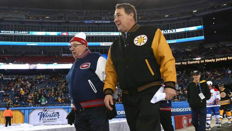 Coach Jacques Demers of the Montreal Canadiens Alumni Team and Coach Mike Milbury of the Boston Bruins Alumni Team walk toward their respective benches in between periods during the Alumni Game as part of the 2016 Bridgestone NHL Classic at Gillette Stadium on December 31, 2015 in Foxboro, Massachusetts.
