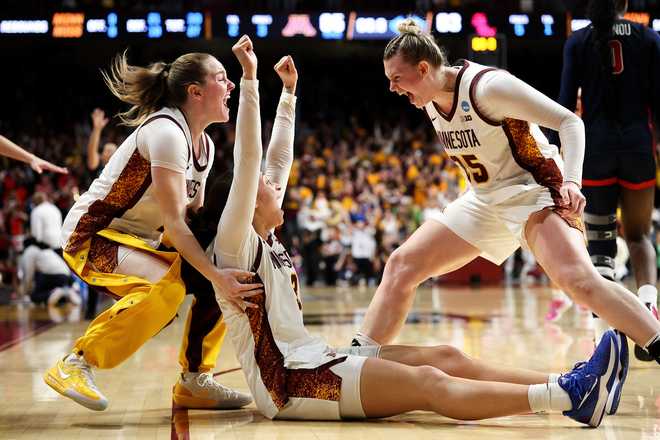Minnesota guard Amaya Battle, center, celebrates after her winning basket against Mississippi during the second half in the second round of the NCAA college basketball tournament, Sunday, March 22, 2026, in Minneapolis.